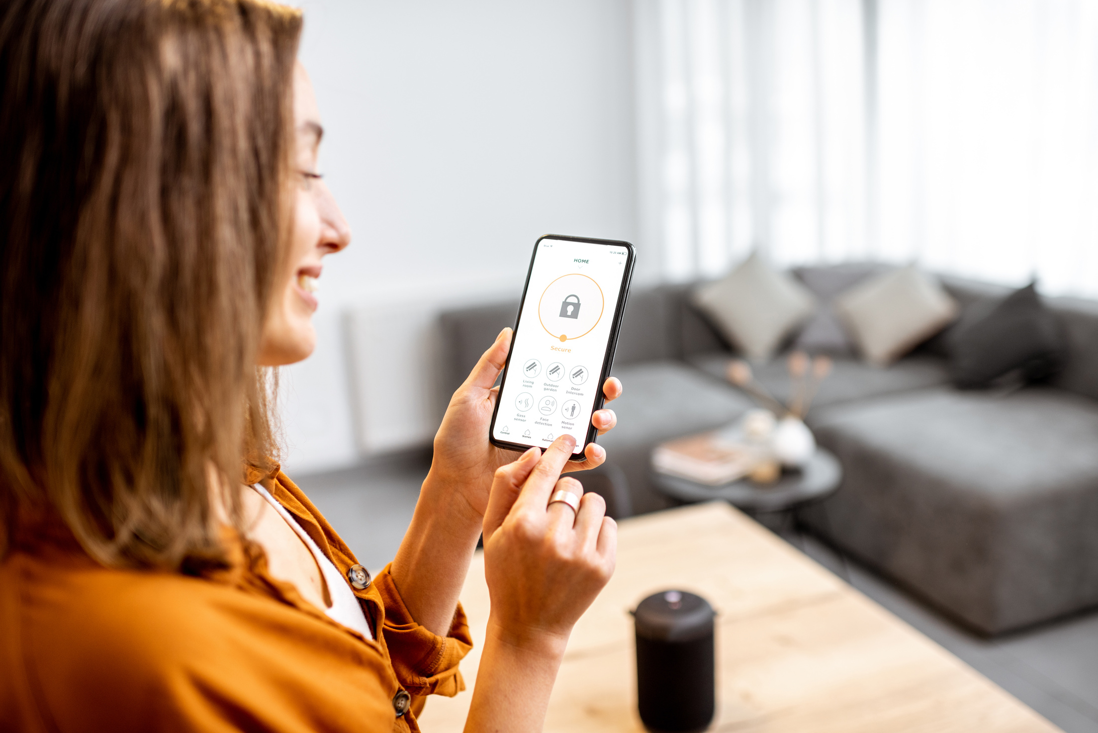 Woman controlling security from a mobile device